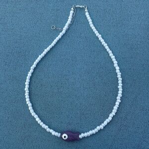 Elegant White Beaded Necklace with Purple Accent